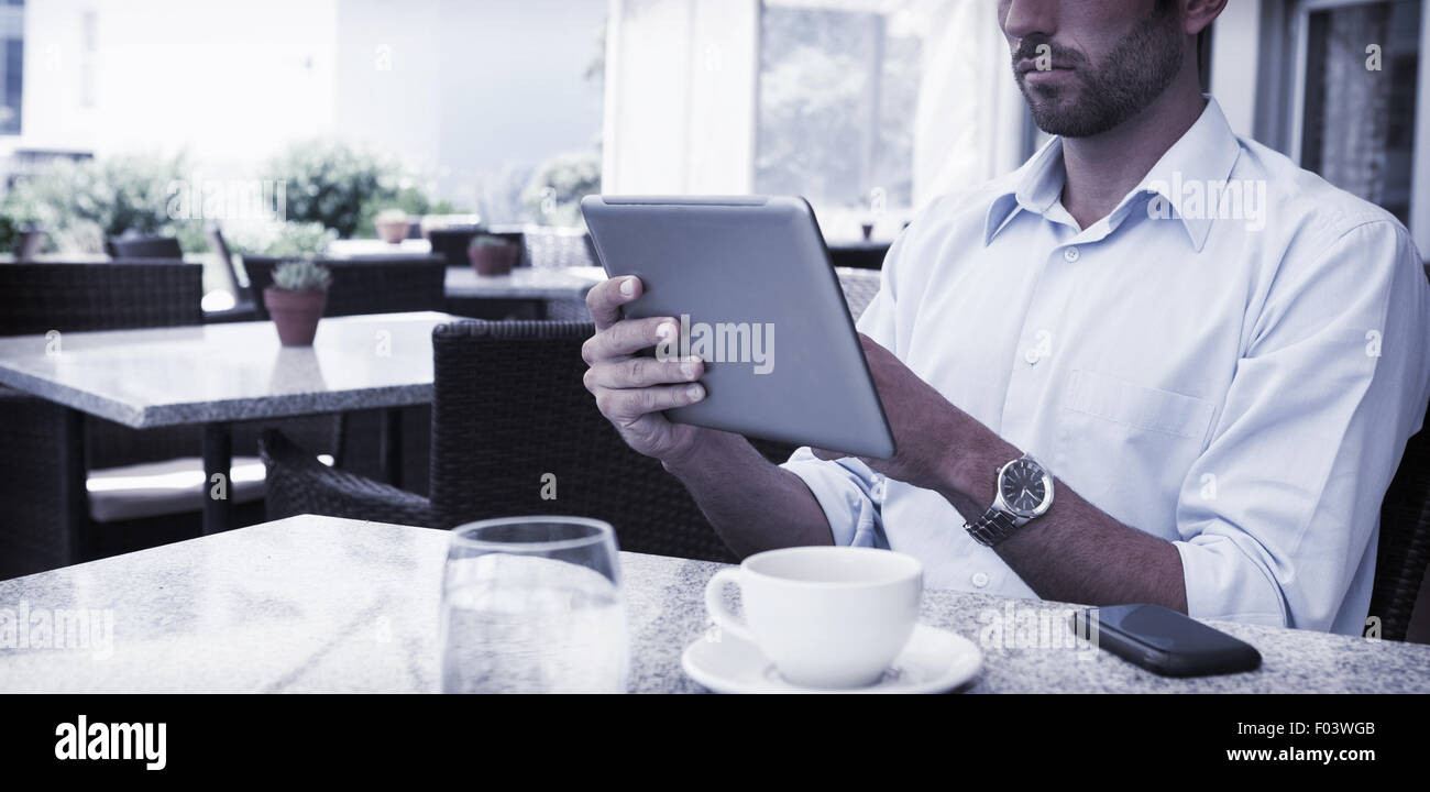 Focused young businessman working on tablet Stock Photo