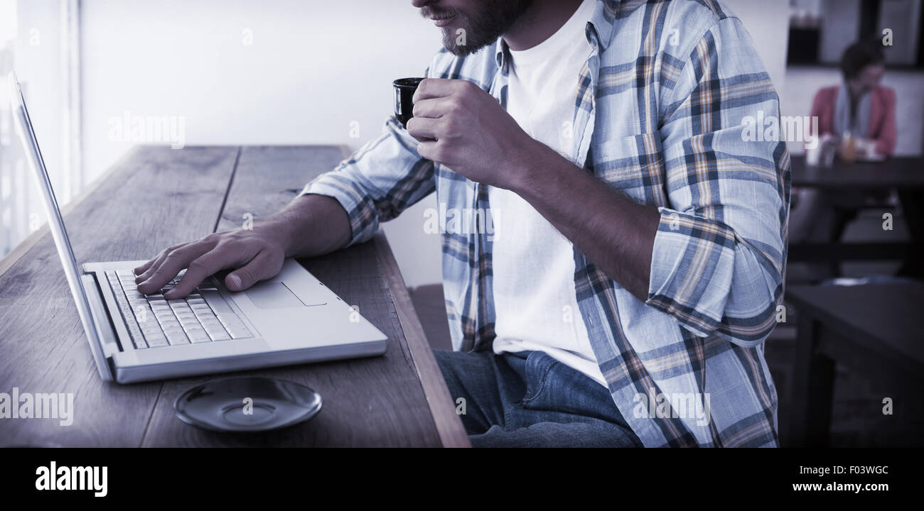 Casual man using laptop drinking espresso Stock Photo