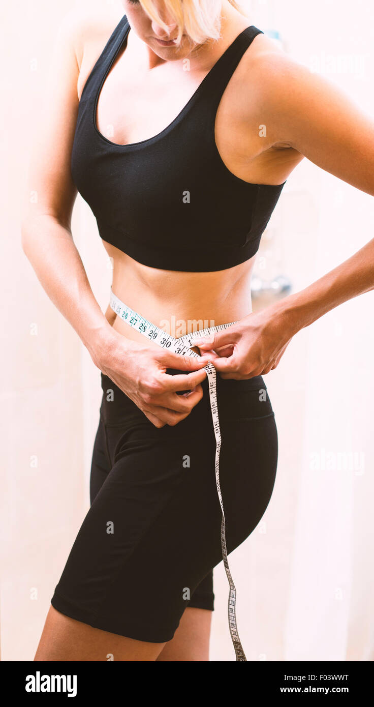 Woman measuring body with measuring tape Stock Photo