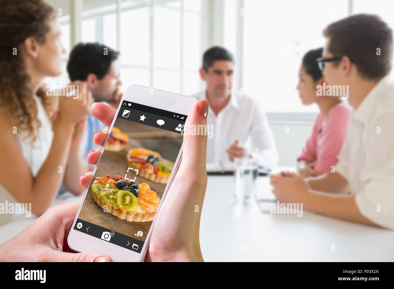 Composite image of hand holding smartphone Stock Photo