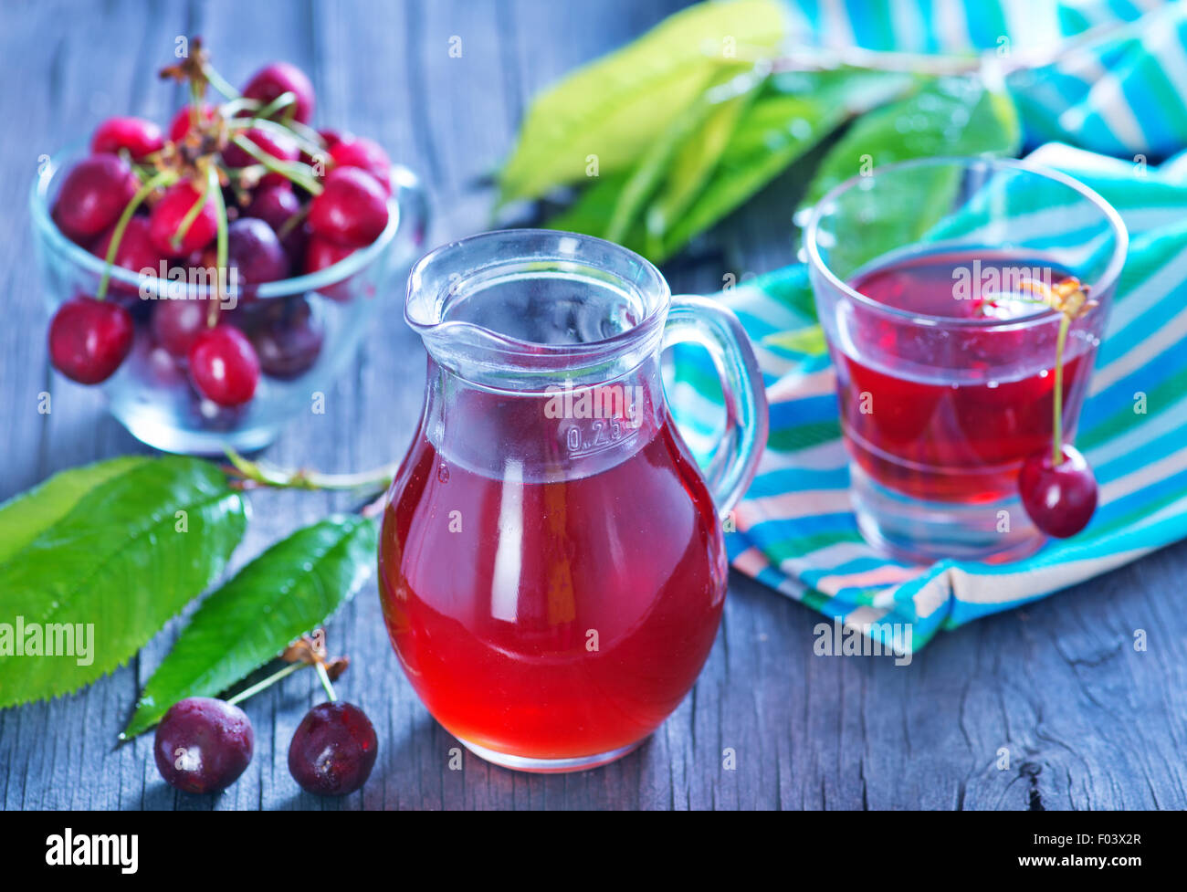 cherry juice in glass jug and on a table Stock Photo Alamy