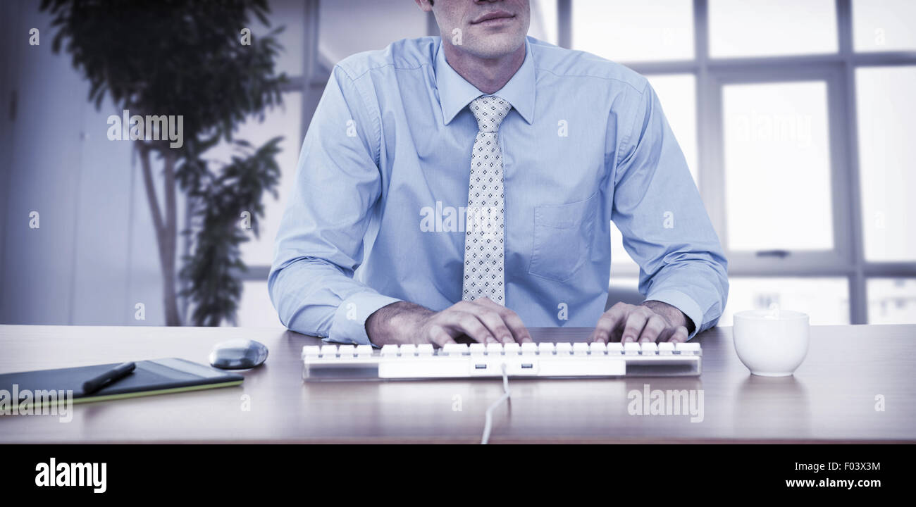 Businessman typing at his desk Stock Photo