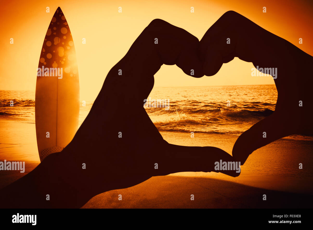 Composite image of couple making heart shape with hands Stock Photo - Alamy