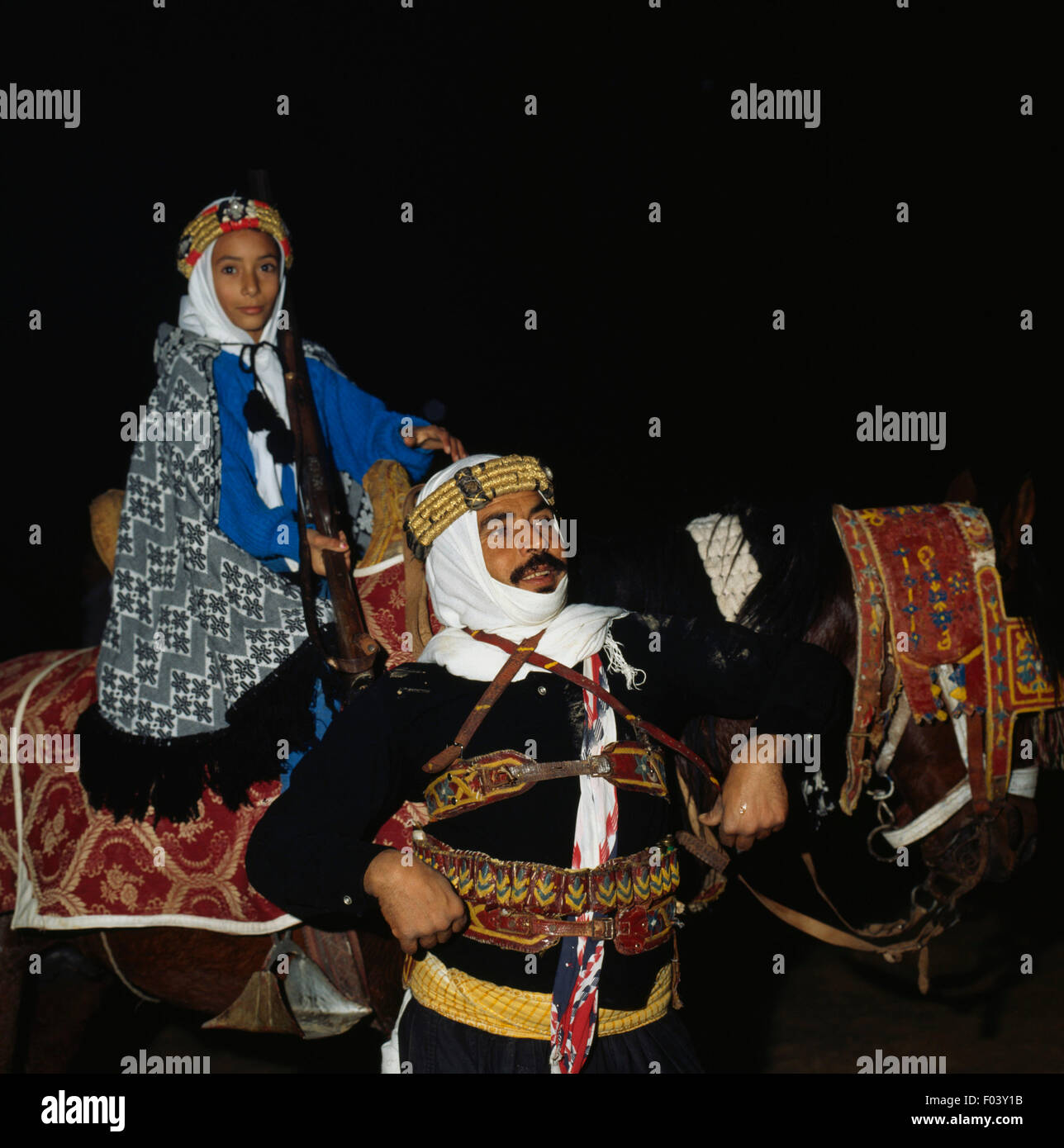 Men and child in traditional clothes, Berber festival, Douz, Tunisia. Stock Photo