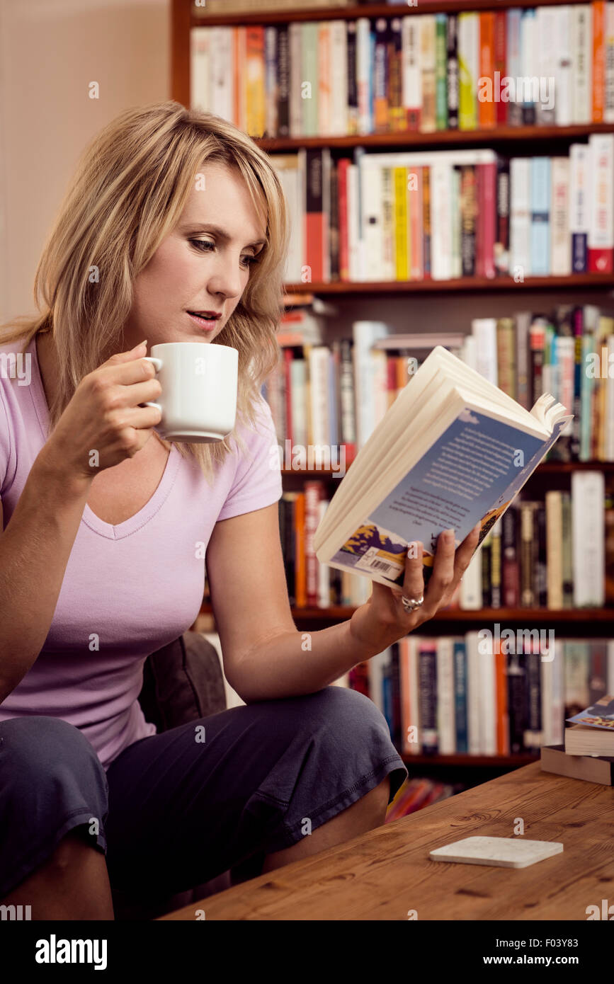 Woman reading at home Stock Photo