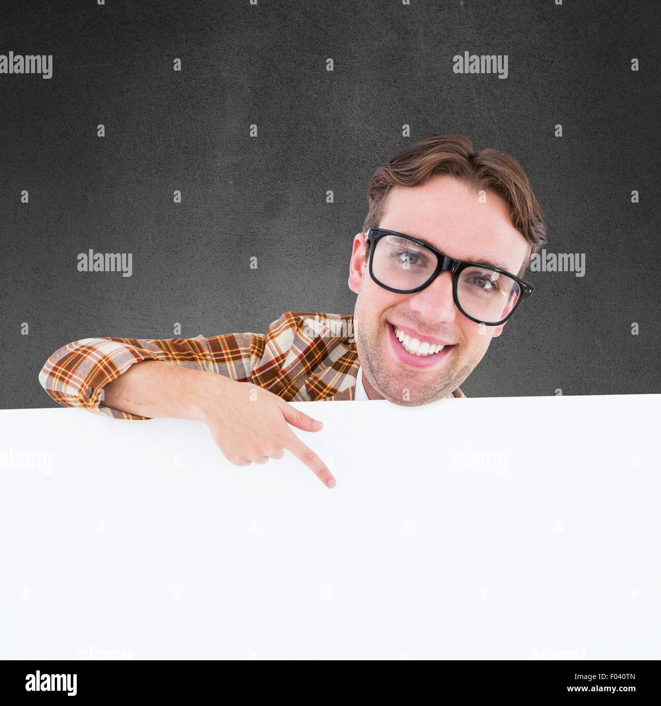 Composite image of nerdy businessman pointing to poster Stock Photo