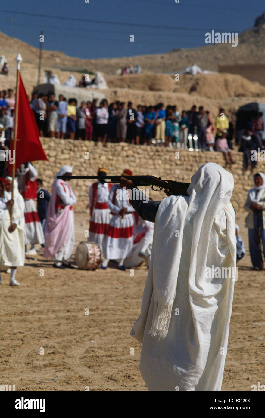 Man in traditional clothes aiming a rifle, Matmata Berber festival, Tunisia. Stock Photo