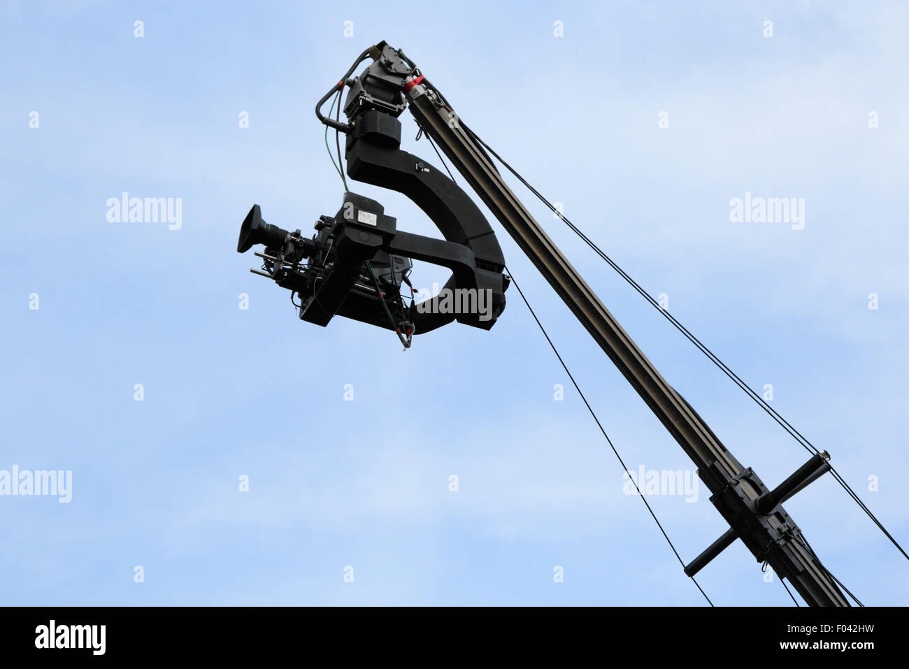 Professional TV camera on a crane against sky. Stock Photo