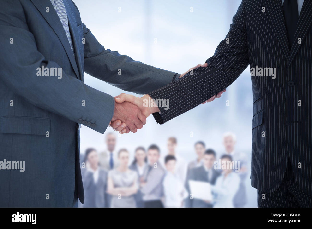 Composite image of handshake in agreement Stock Photo