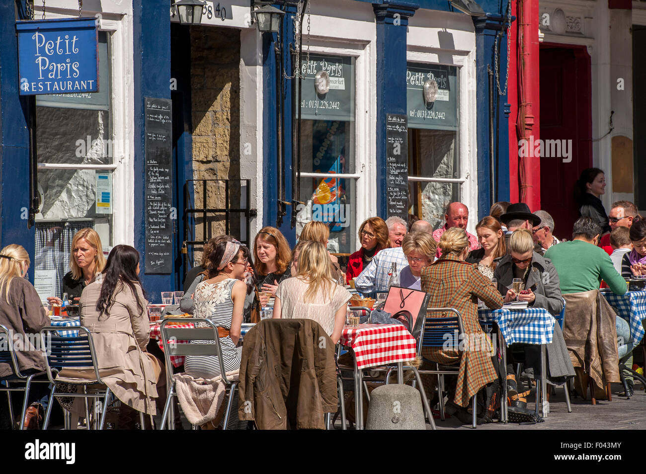 People dining outside a restaurant on a summer's day in Edinburgh