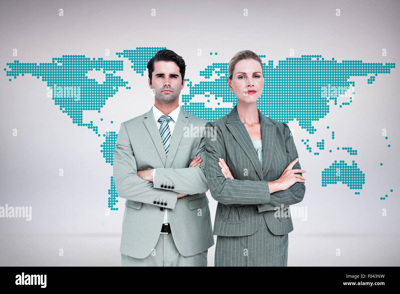 Composite image of business people with arms crossed looking at camera Stock Photo