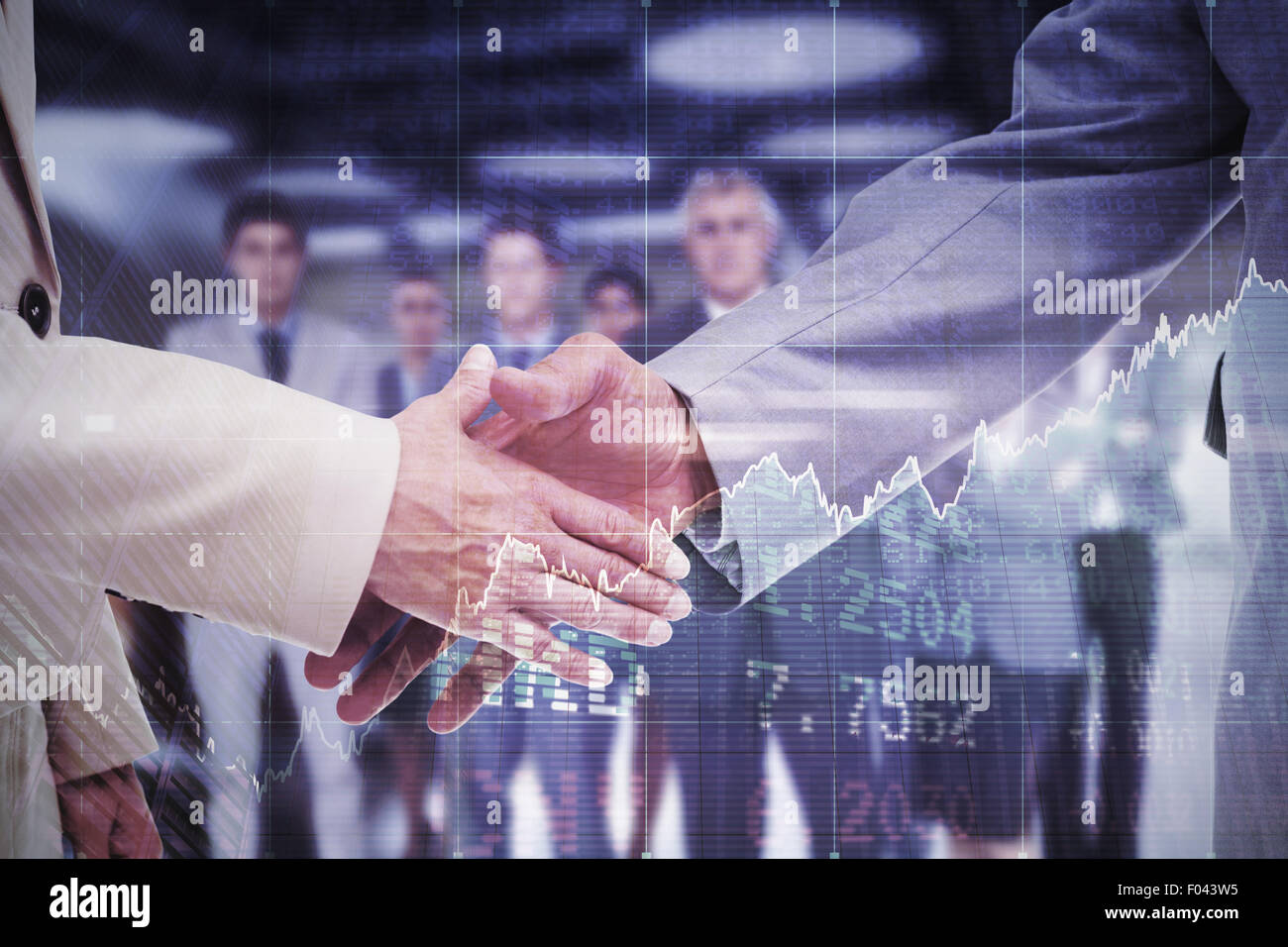 Composite image of close up of business people shaking their hands Stock Photo
