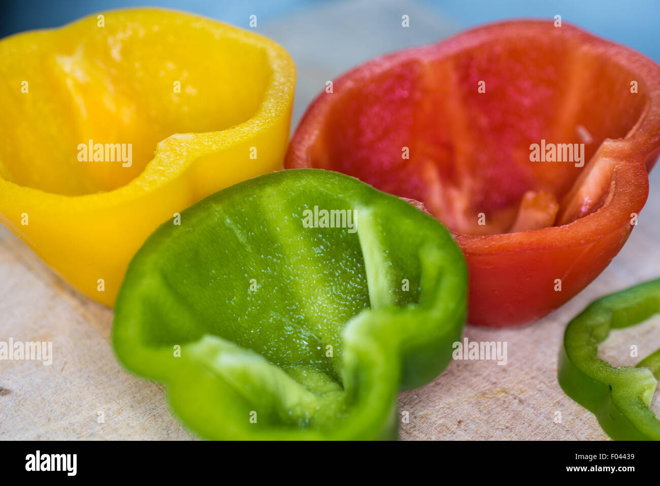 A green, yellow and red pepper being prepared Stock Photo
