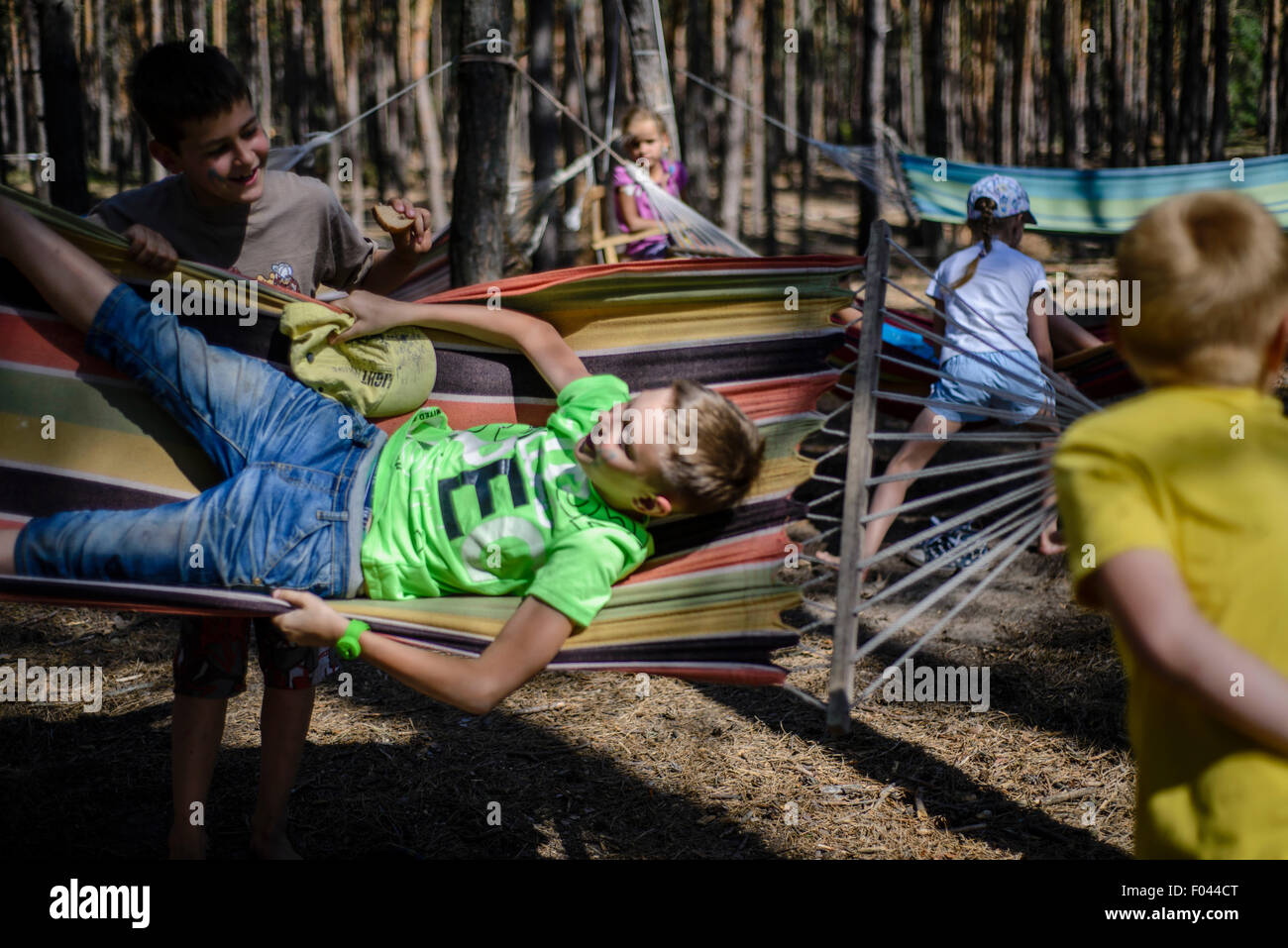 Children playing on hammocks Ukrainian scout training camp, Kiev region