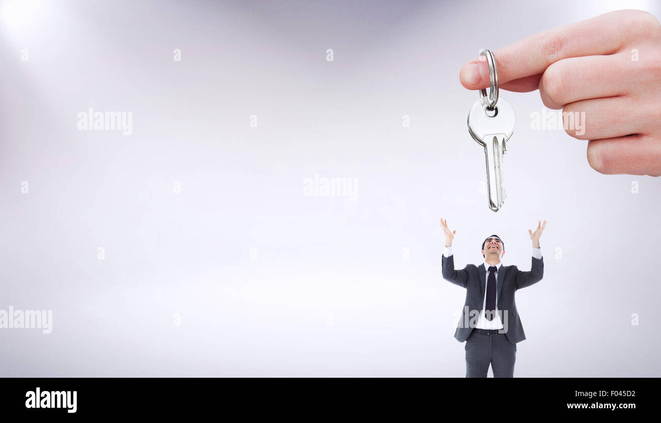 Composite image of focus shot on a woman holding a key Stock Photo