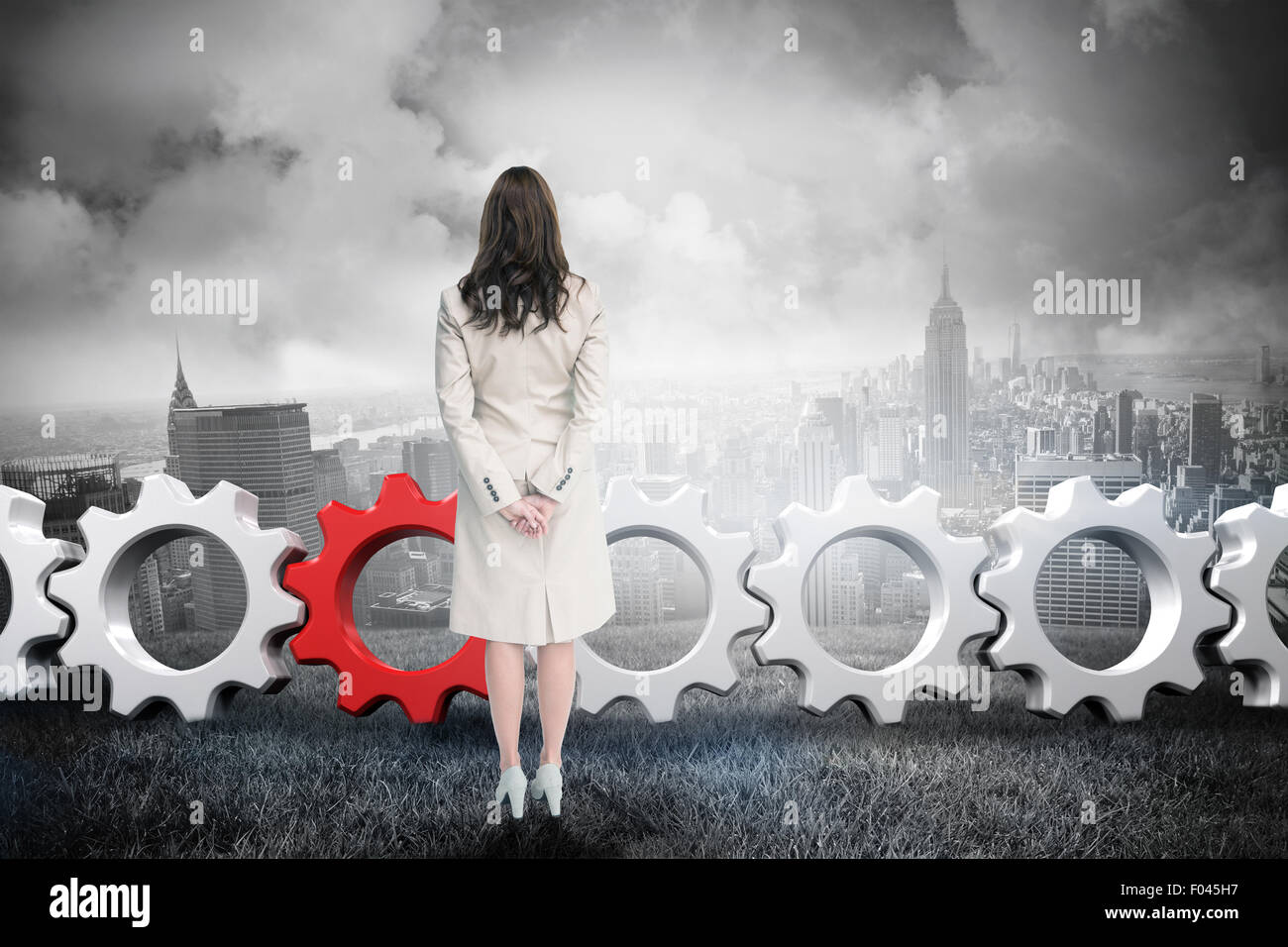 Composite image of rear view of businesswoman Stock Photo - Alamy