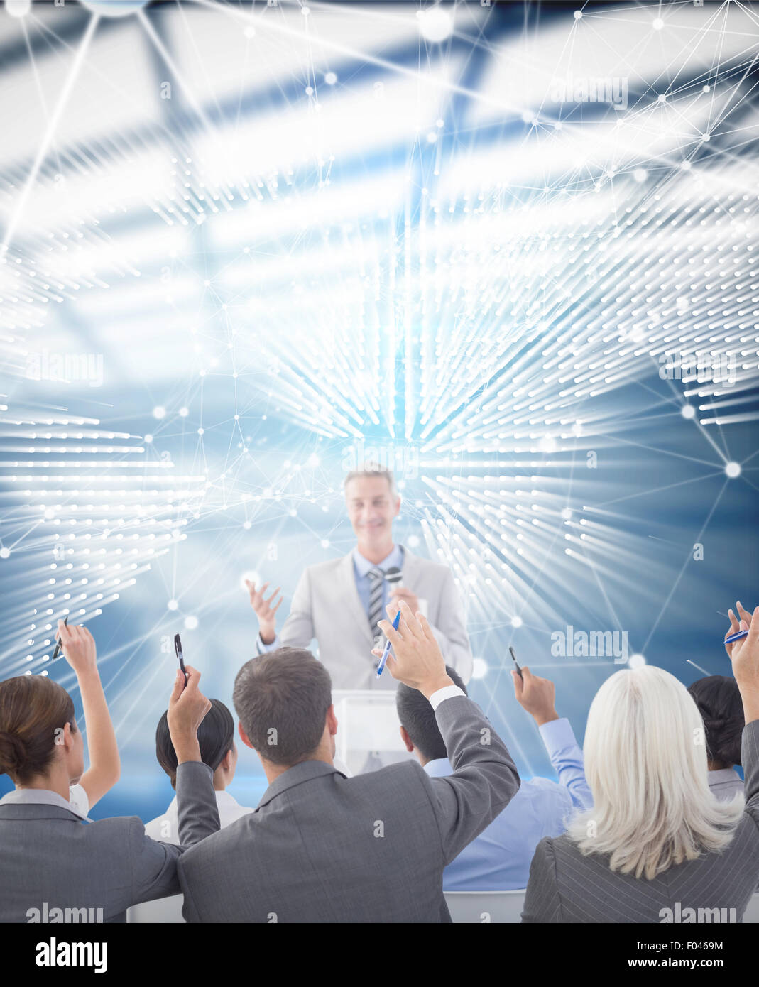 Composite image of business people raising their arms during meeting Stock Photo