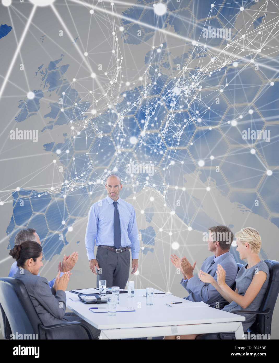 Composite image of business people applauding during meeting Stock Photo