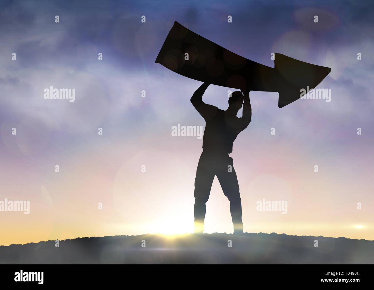 Composite image of businessman holding arrow Stock Photo - Alamy