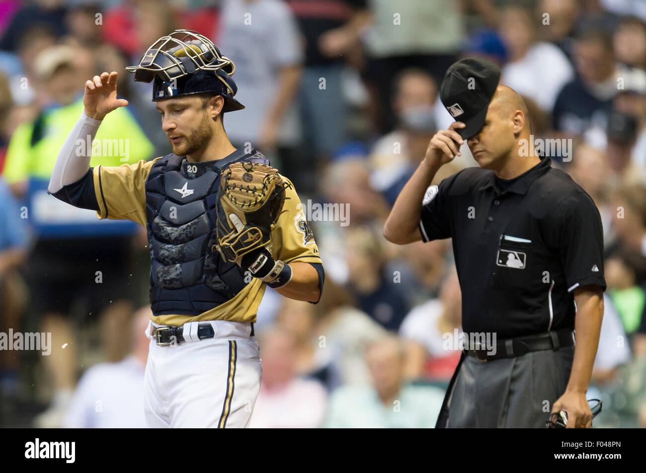 Milwaukee, WI, USA. 05th Aug, 2015. Milwaukee Brewers catcher Jonathan Lucroy #20 and Home Plate Umpire Vic Carapazza during the Major League Baseball game between the Milwaukee Brewers and the San Diego Padres at Miller Park in Milwaukee, WI. John Fisher/CSM/Alamy Live News Stock Photo