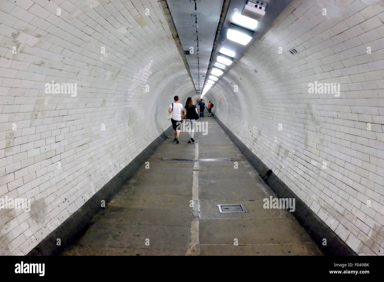 People walking in Greenwich foot tunnel Stock Photo