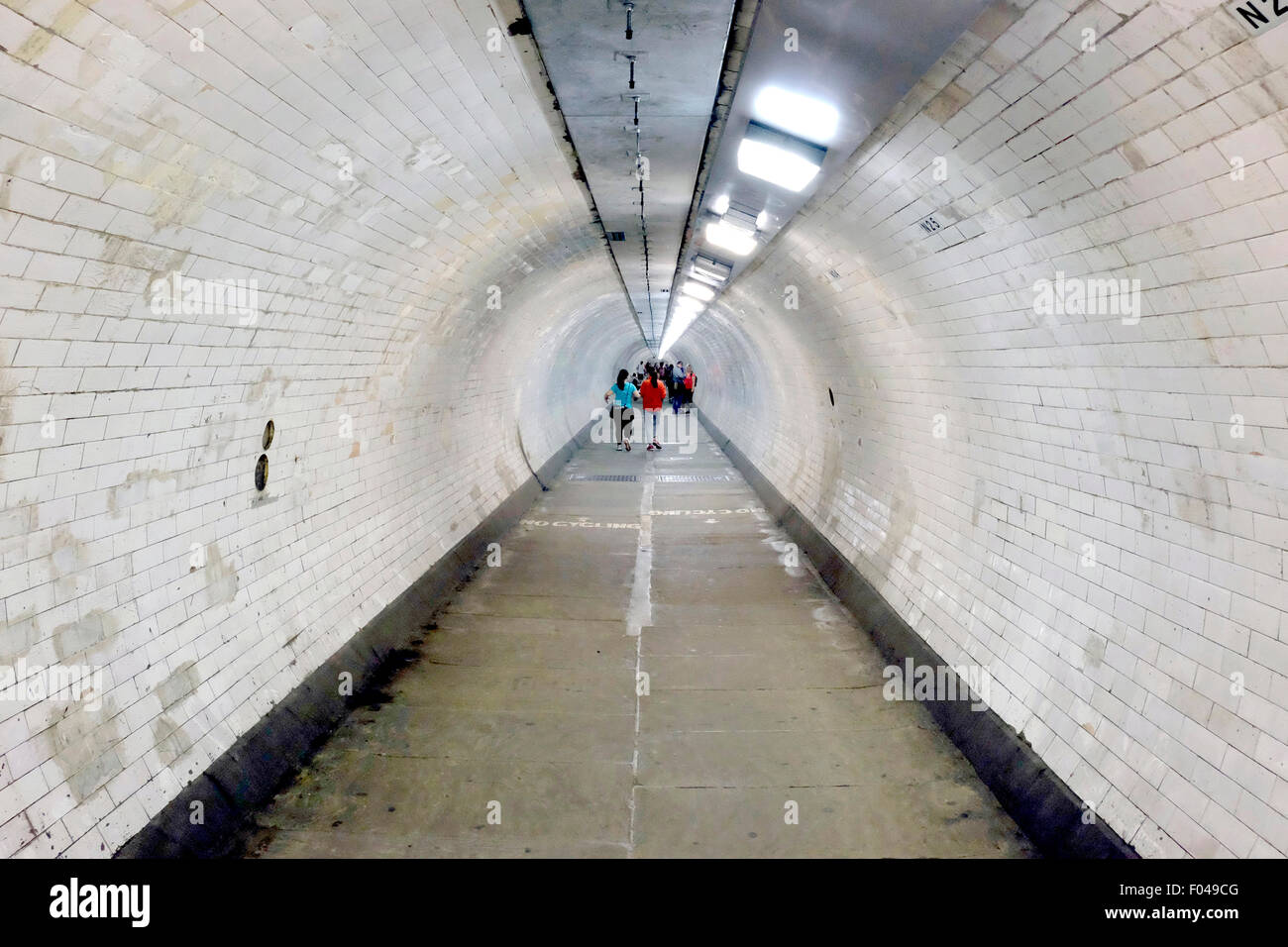 People walking in Greenwich tunnel Stock Photo