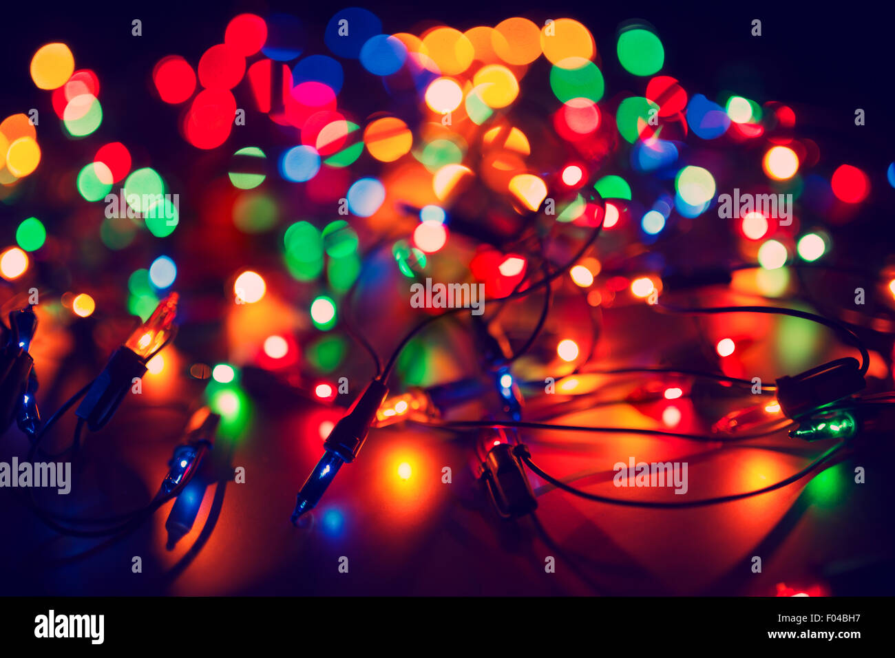 Christmas lights on dark background. Decorative garland. Tinted photo Stock Photo
