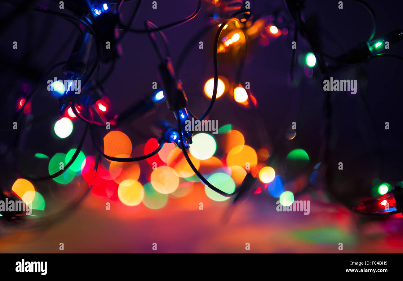 Christmas lights on dark background. Decorative garland. Tinted photo Stock Photo