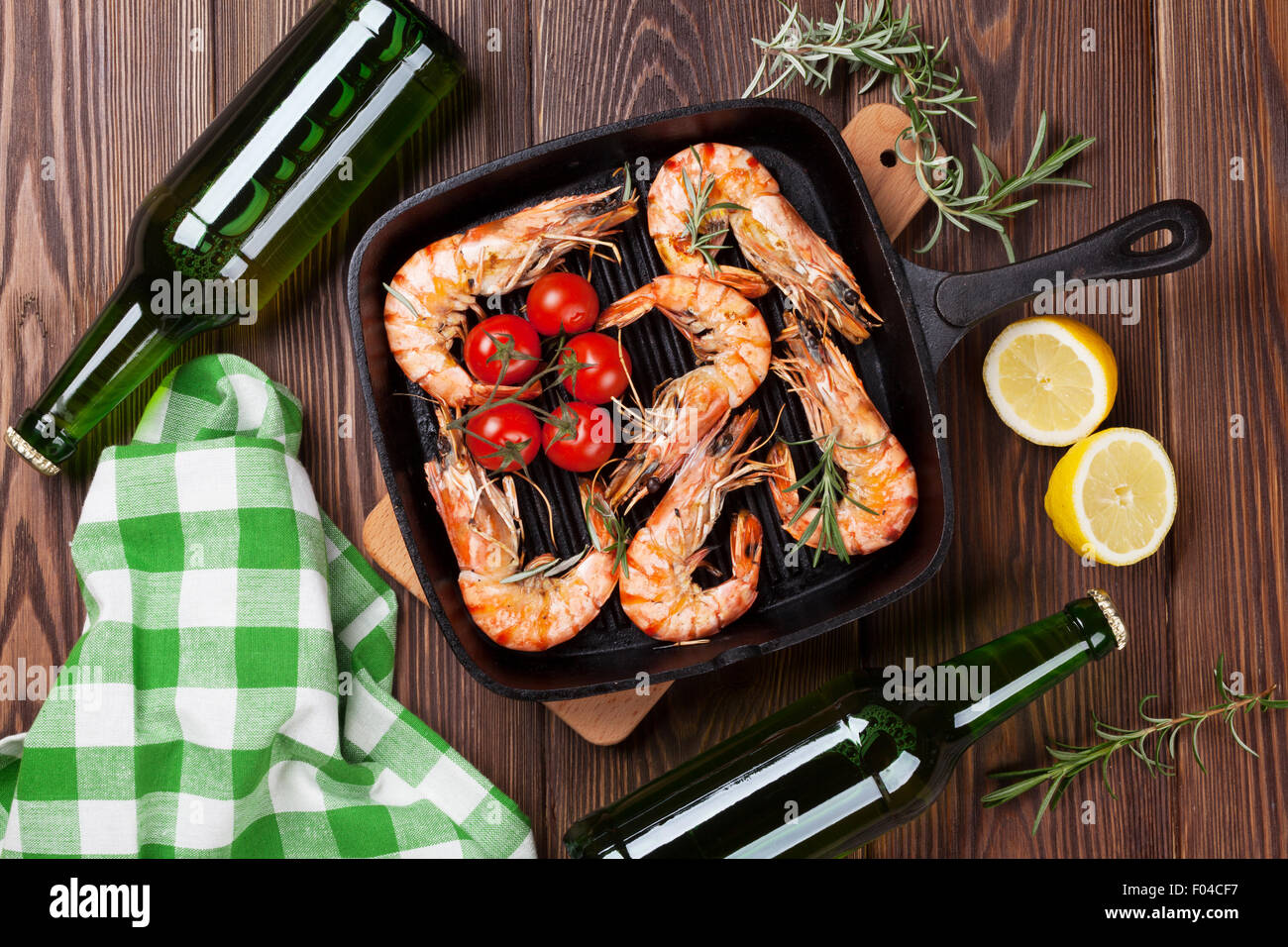 Grilled shrimps on frying pan and beer. Top view Stock Photo