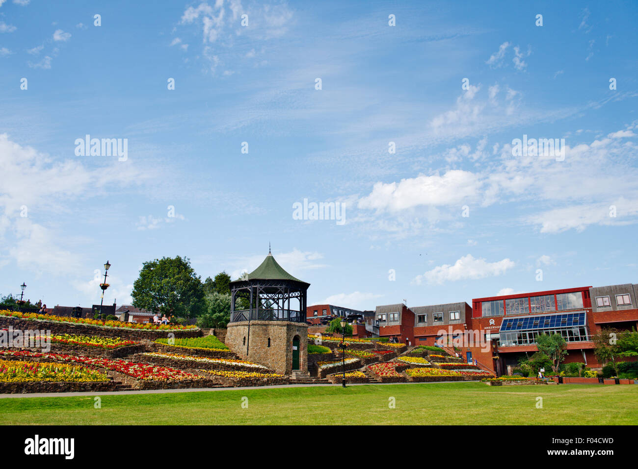 Tamworth Castle gardens, bandstand and flower beds in bloom with Ankerside Shopping Centre, Staffordshire Stock Photo