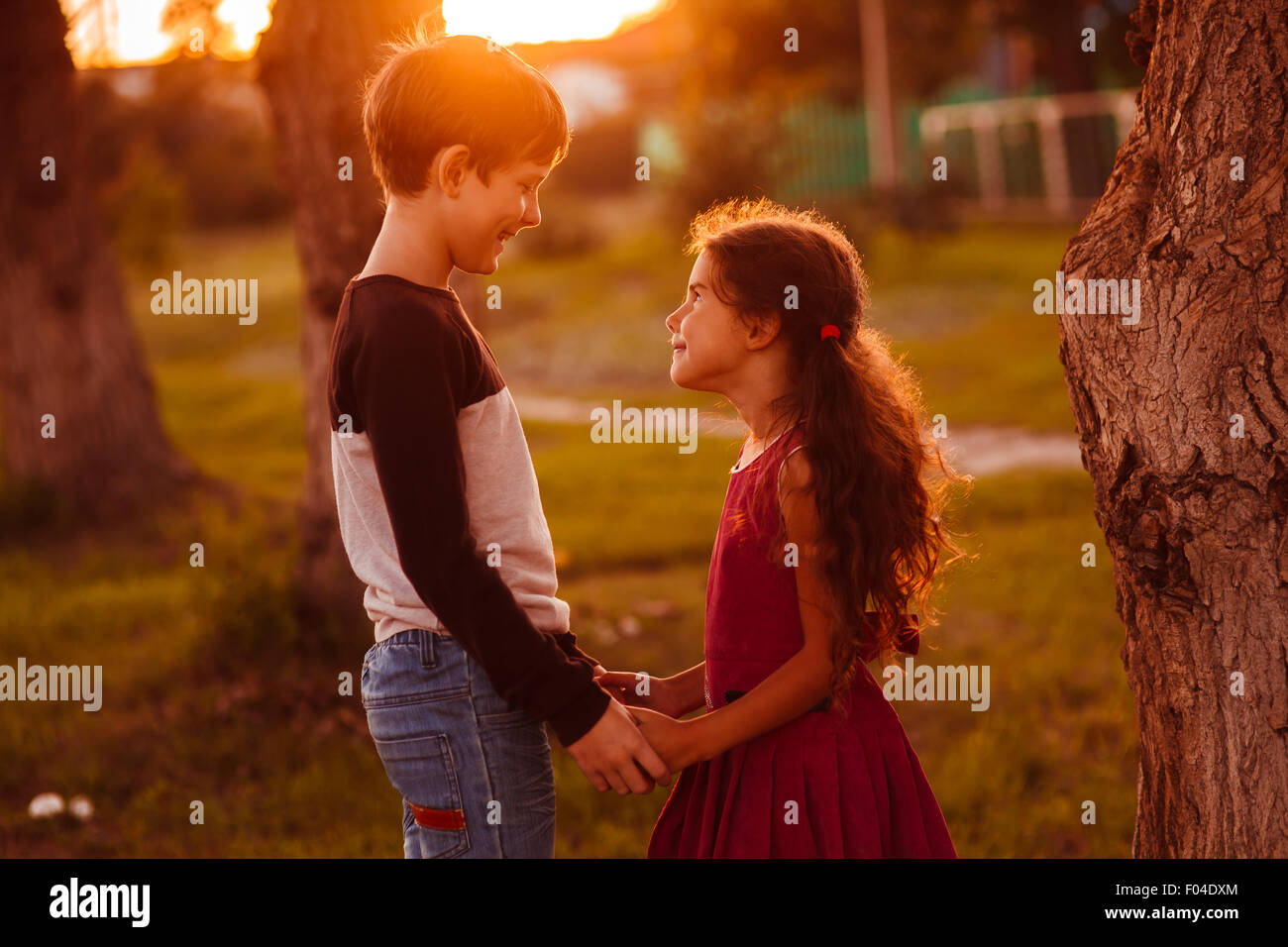boy girl teens are holding hands romance friendship love at suns Stock Photo  - Alamy, image size:1300x956