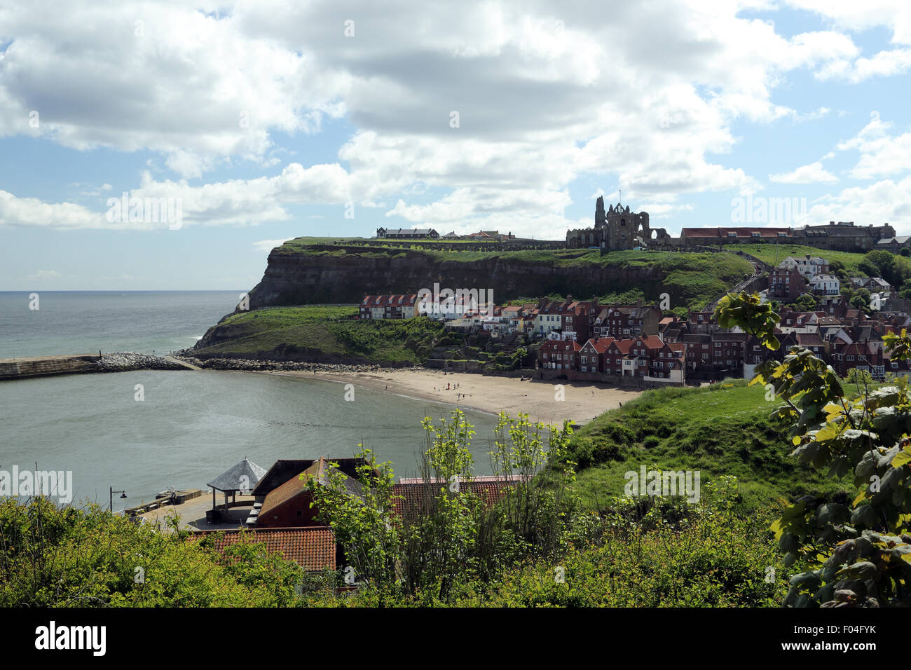 Looking along the beach at Whitby, with the Abbey ruins atop the hill towards the top right of the photo. Stock Photo