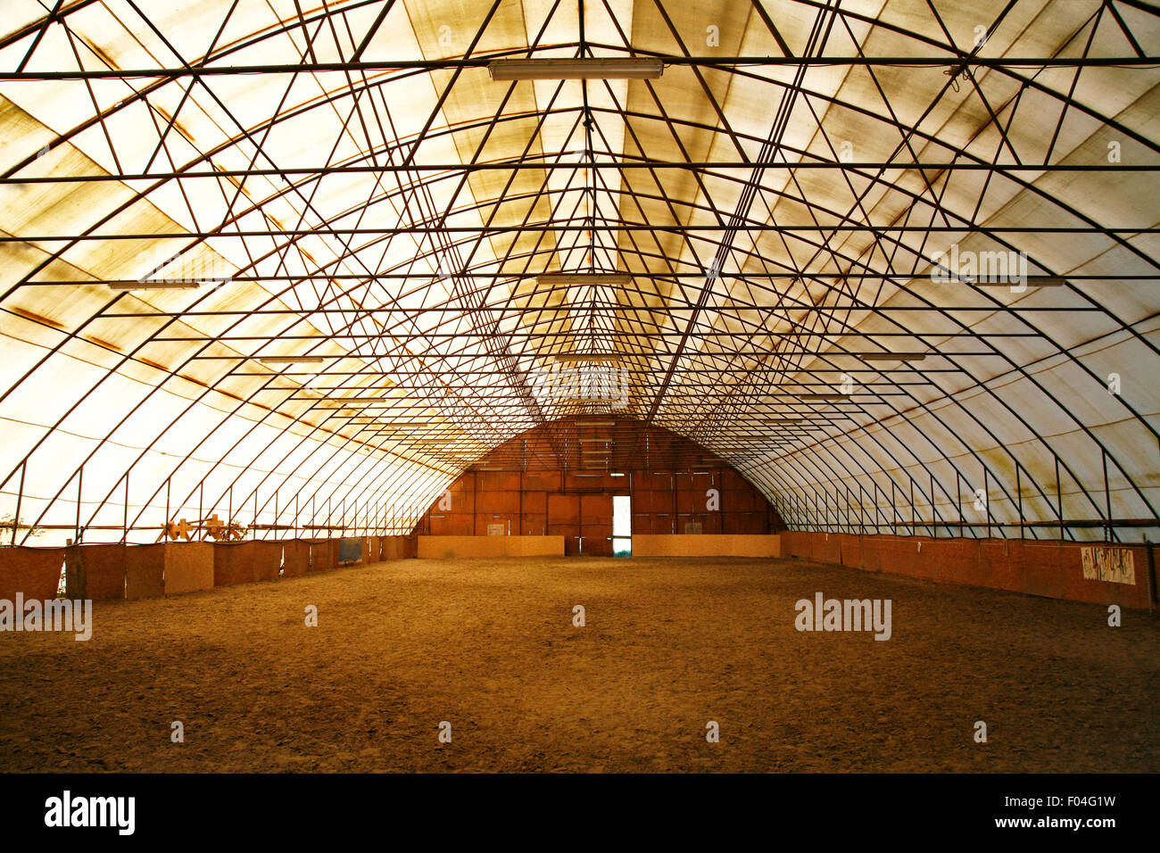 Indoor riding arena covering sand for trainings Stock Photo