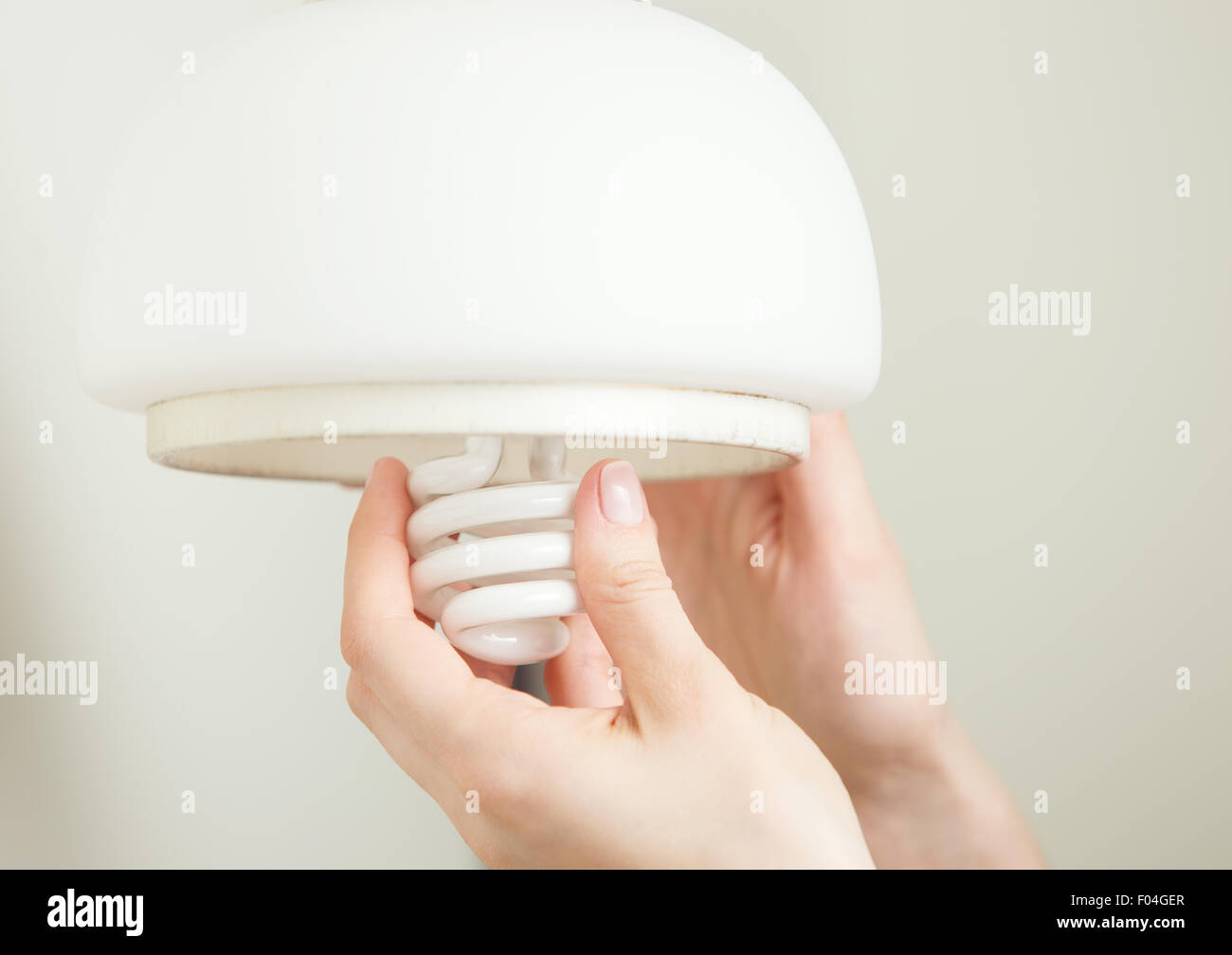 Installing energy efficient compact fluorescent light Stock Photo