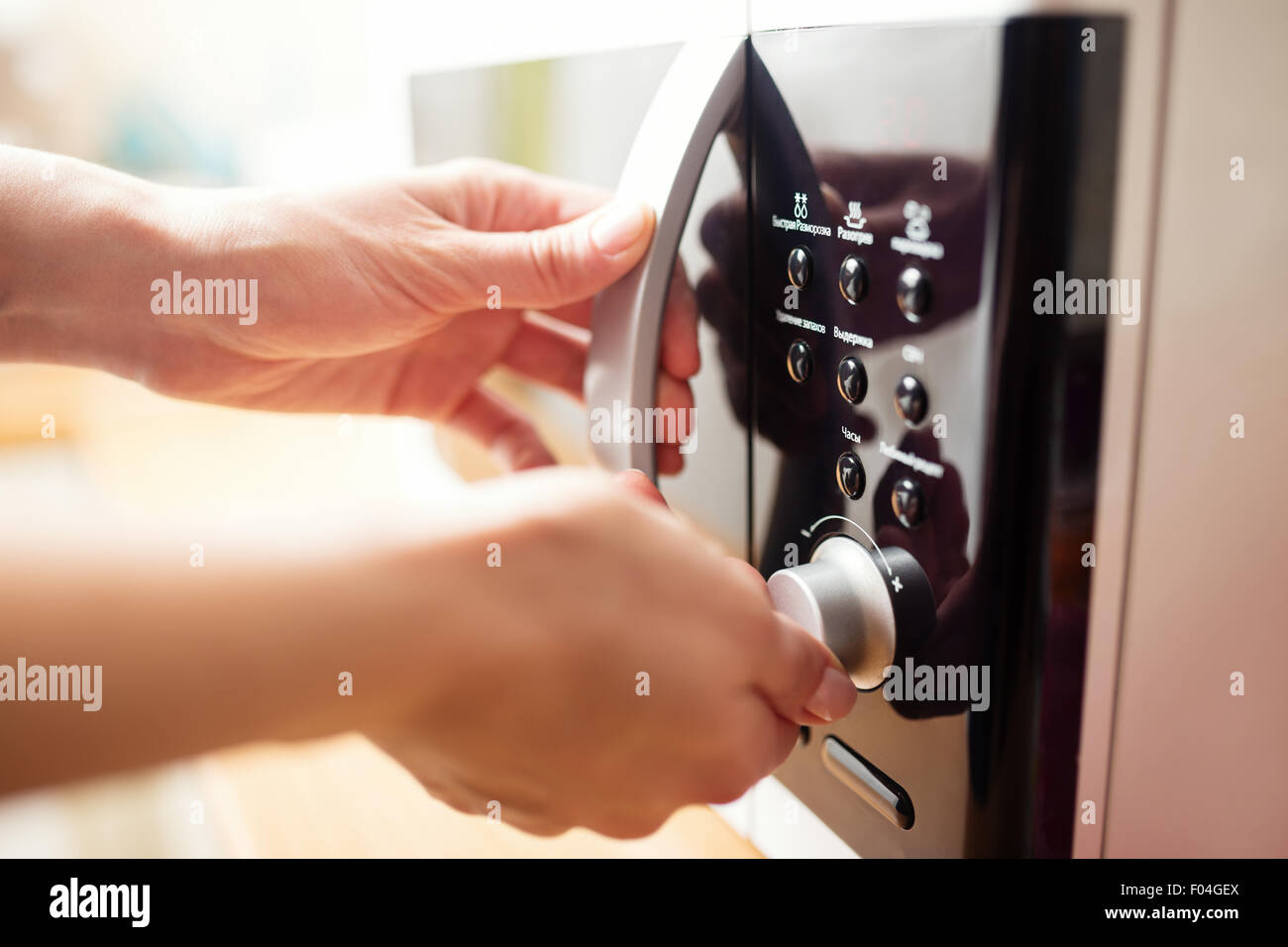 Using microwave oven, close up photo, shallow dof Stock Photo