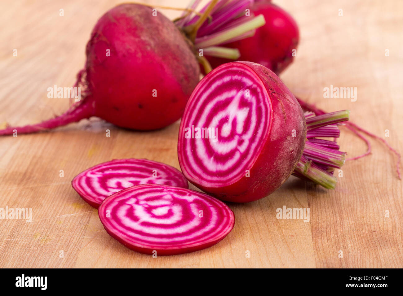Chioggia striped or candy stripe beet  whole and sliced on wood table Stock Photo