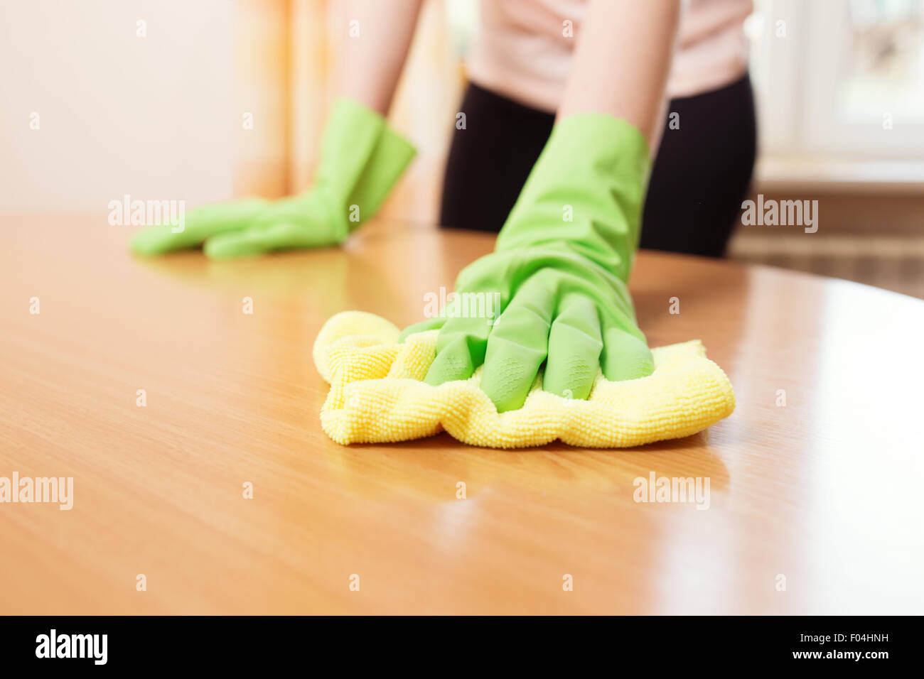 Woman cleaning stains off the table, close up photo Stock Photo