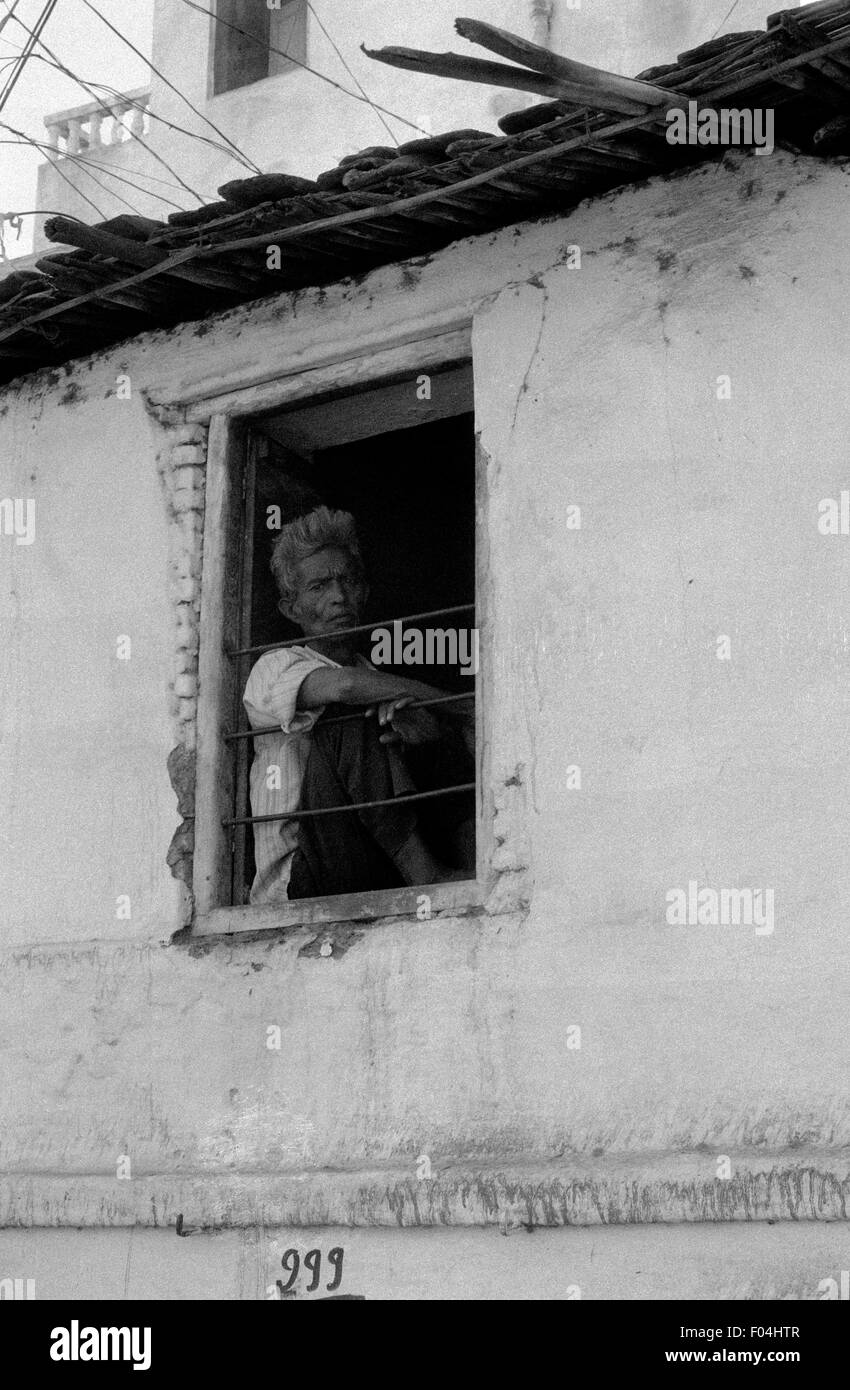 indian man looking out window brian mcguire Stock Photo