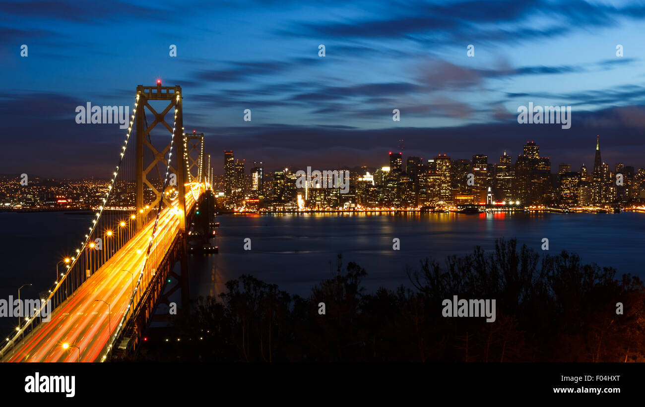 San Francisco Bay Bridge and skyline at night with city lights Stock Photo