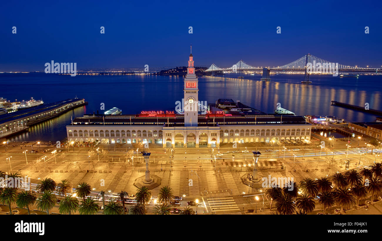 Ferry Building and Bay Bridge illuminated at night in San Francisco, California Stock Photo
