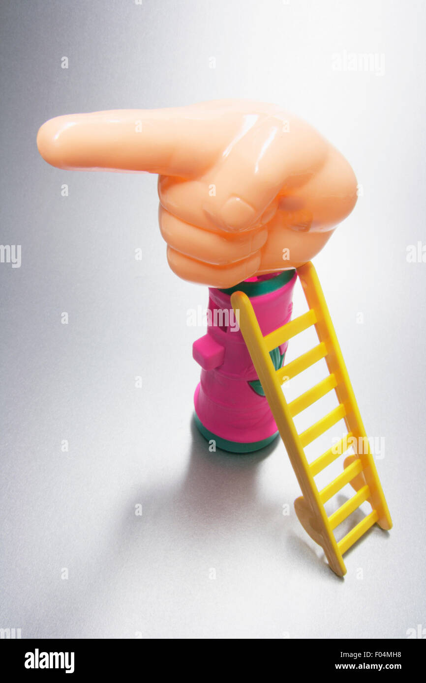 Plastic Hand and Miniature Ladder Stock Photo