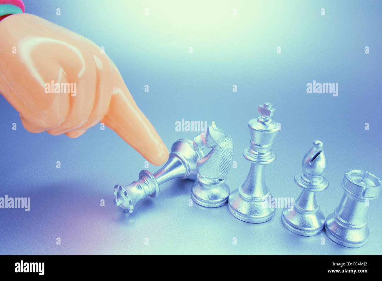 Plastic Hand and Chess Pieces Stock Photo