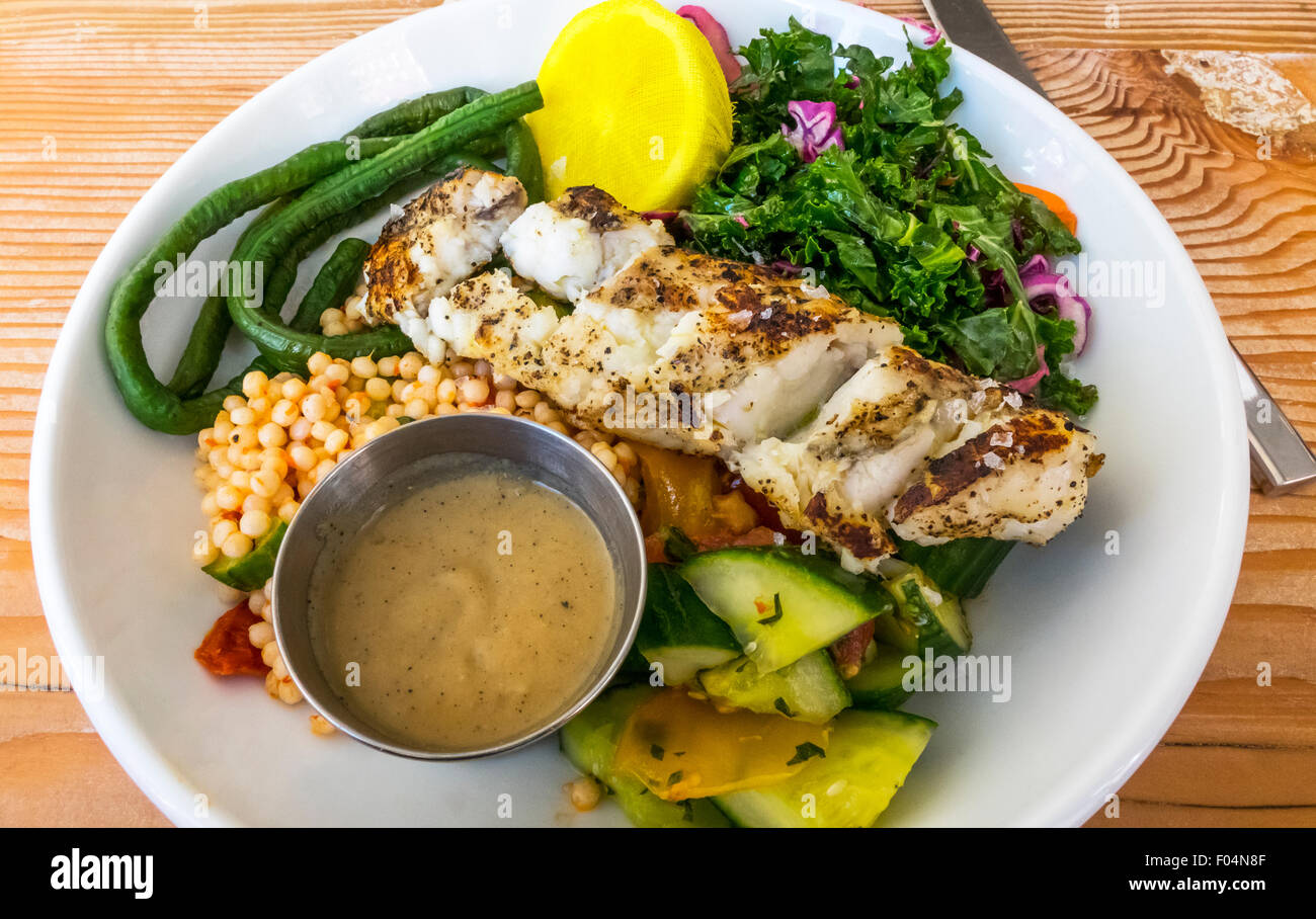 Grilled monkfish with veggies, salad, and chick peas with a brown butter sauce and lemon Stock Photo