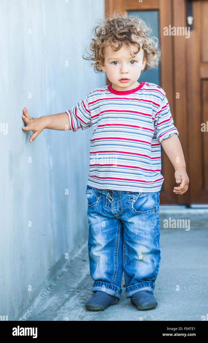 Portrait of 1 year old baby boy walking outside the house Stock Photo ...