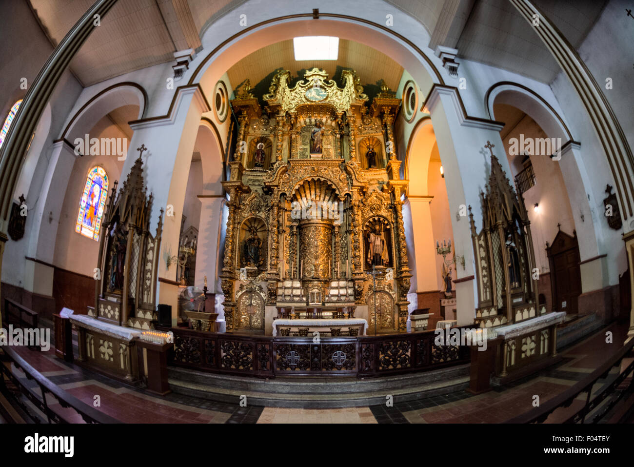 Altar de Oro Iglesia San José Panama City // PANAMA CITY, Panama — The golden altar (Altar de Oro) at Iglesia San José stands as one of Panama's most significant colonial religious artifacts. According to historical accounts, this carved mahogany altar, covered in gold paint, survived pirate Henry Morgan's 1671 raid on Panama Viejo when quick-thinking priests concealed it under black paint. The altar was later relocated to its present site in Iglesia San José, constructed in 1673 in what is now the Casco Viejo historic district. Stock Photo