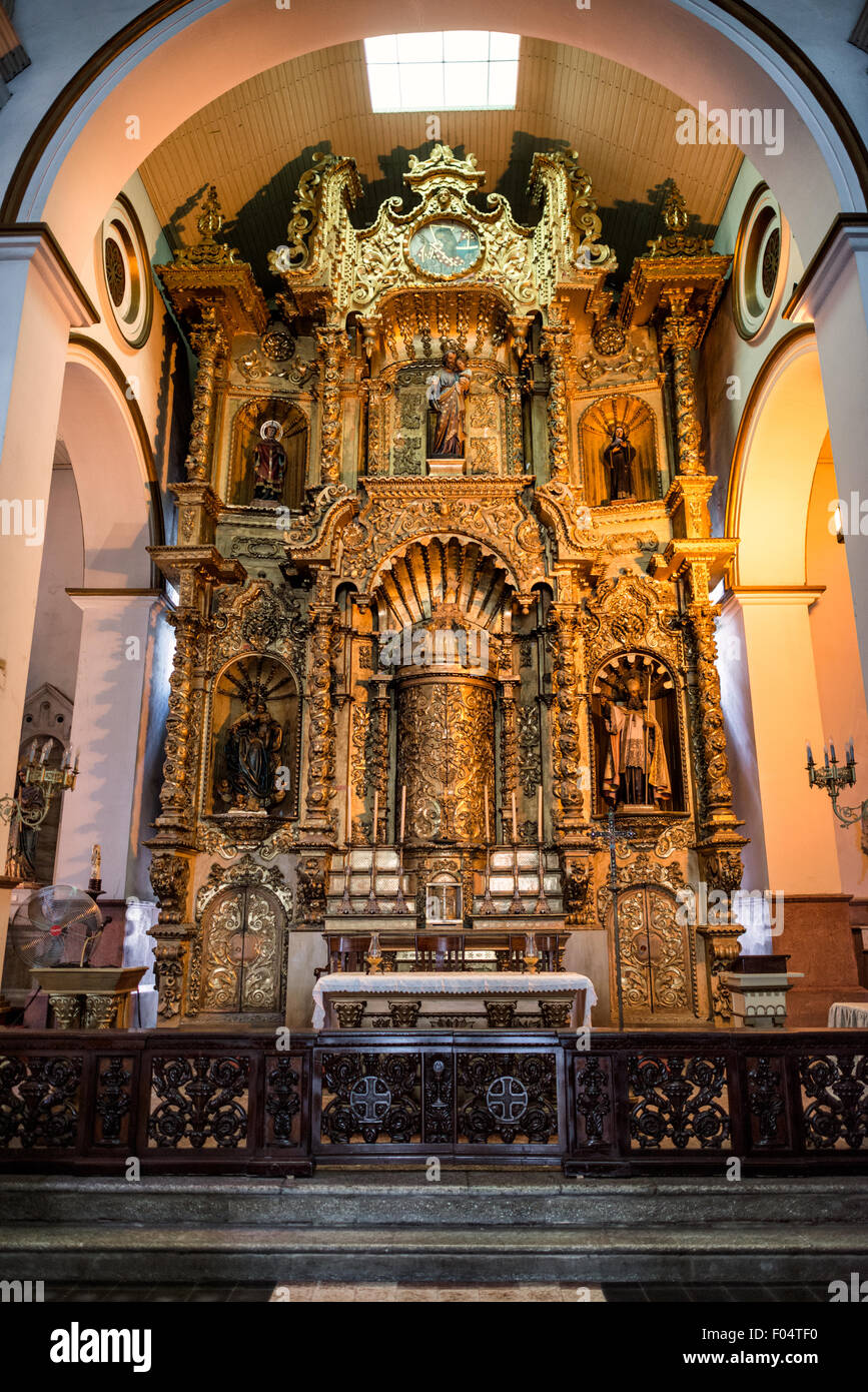 Altar de Oro Iglesia San José Panama City // PANAMA CITY, Panama — The golden altar (Altar de Oro) at Iglesia San José stands as one of Panama's most significant colonial religious artifacts. According to historical accounts, this carved mahogany altar, covered in gold paint, survived pirate Henry Morgan's 1671 raid on Panama Viejo when quick-thinking priests concealed it under black paint. The altar was later relocated to its present site in Iglesia San José, constructed in 1673 in what is now the Casco Viejo historic district. Stock Photo