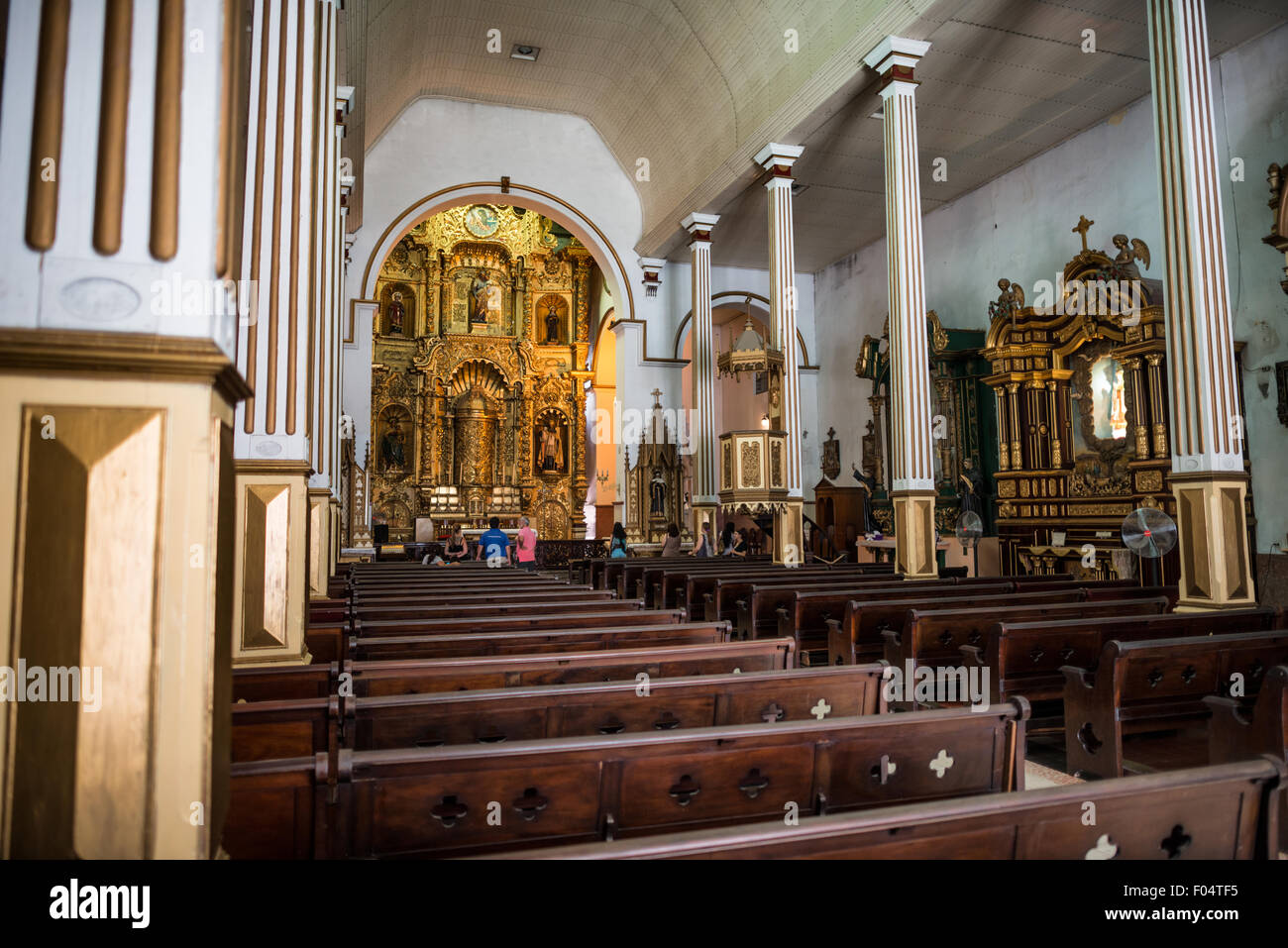 PANAMA CITY, Panama — The massive gold altar of Iglesia San Jose. It survived the pirate Henry Morgan's sacking of Panama Viejo in 1671 when a priest is reputed to have painted it black and convinced Morgan that it had already been stolen. The altar was later moved to its present location in Iglesia San Jose. The altar itself is carved mahagony that is painted with gold. Iglesia San Jose is in the heart of the historic Casco Viejo district of Panama City and dates to 1673. Stock Photo