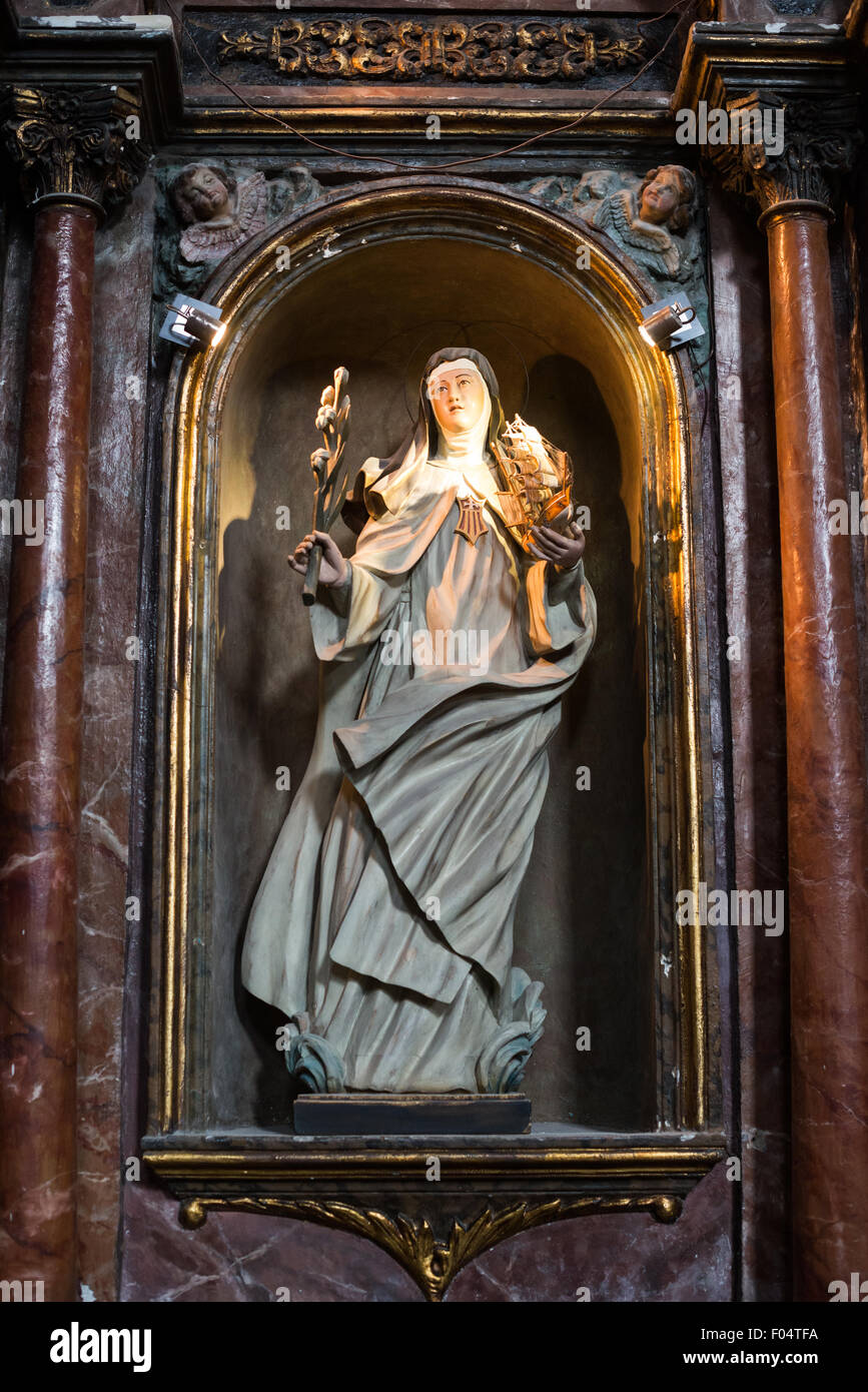 PANAMA CITY, Panama--Dating back to 1680, La Iglesia de la Merced stands in the heart of Casco Viejo, the historic old town of Panama City. Its interior is lavishly decorated with statues and religious art. María de Cervelló was a 13th century Spanish saint. She is often depicted with ships after her legend of being seen after her death on the wings of the wind to protect ships against raging winds. Stock Photo