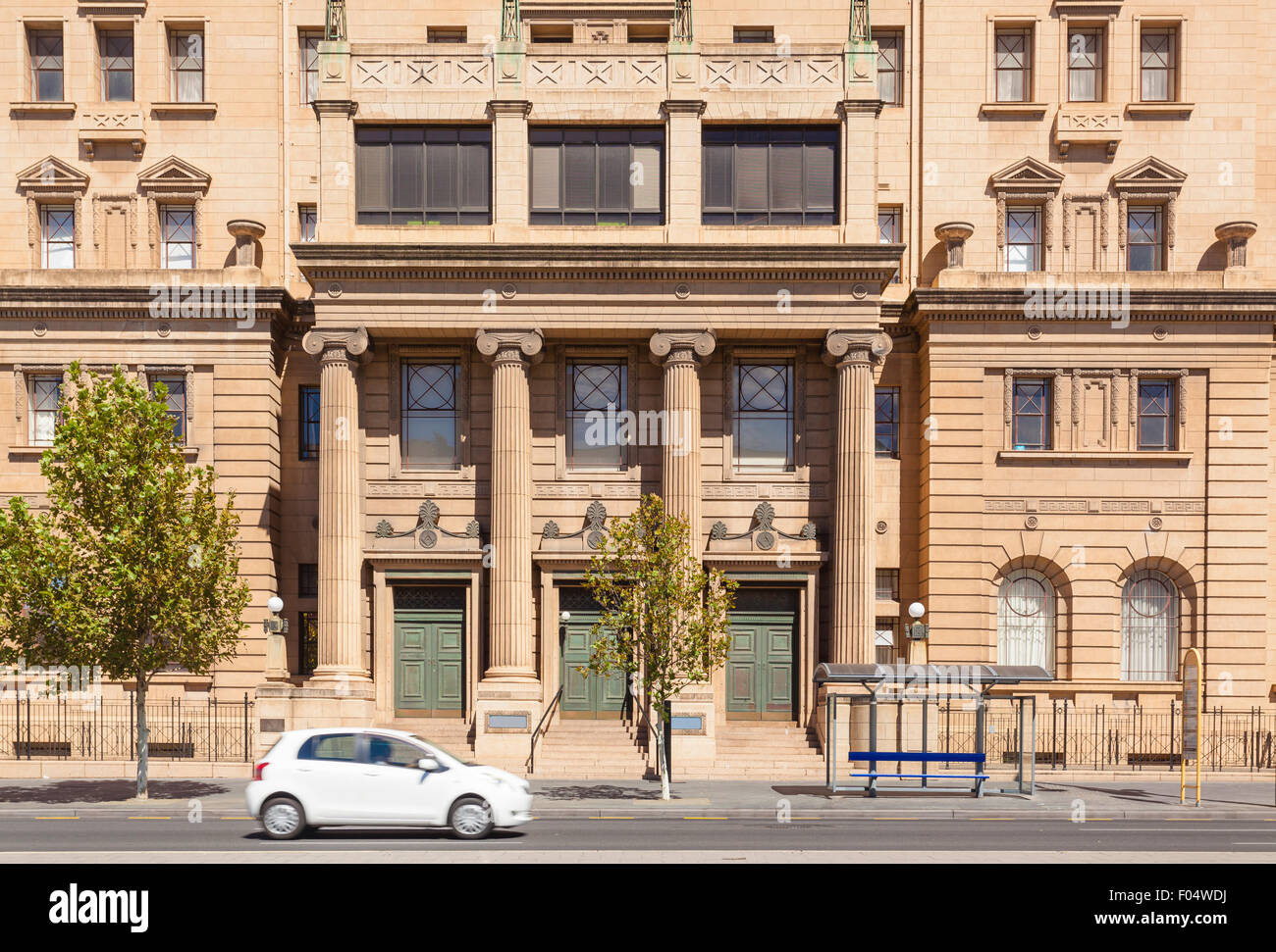 Car on road against a traditional building Stock Photo