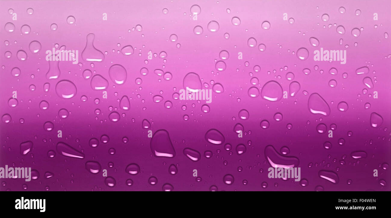 Close view of water drops against a pink background Stock Photo - Alamy